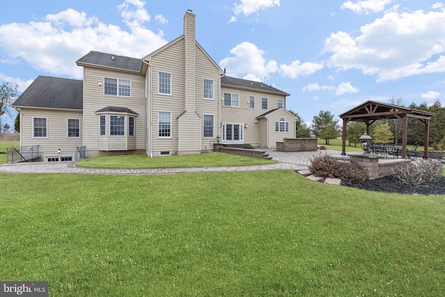 back of property featuring a gazebo, a yard, and a patio area