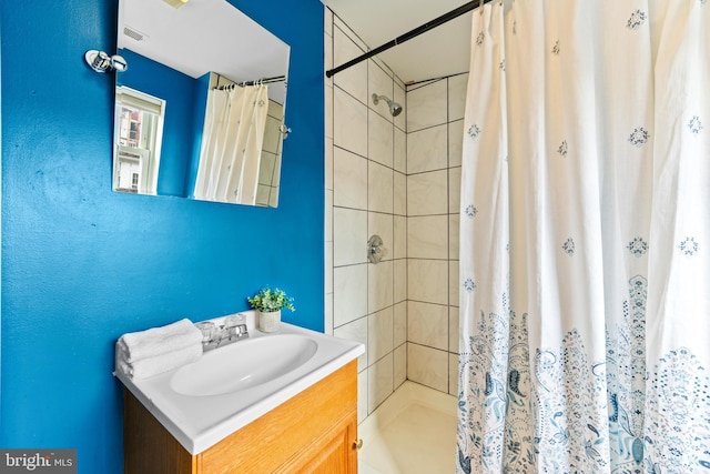 bathroom with a stall shower, visible vents, and vanity