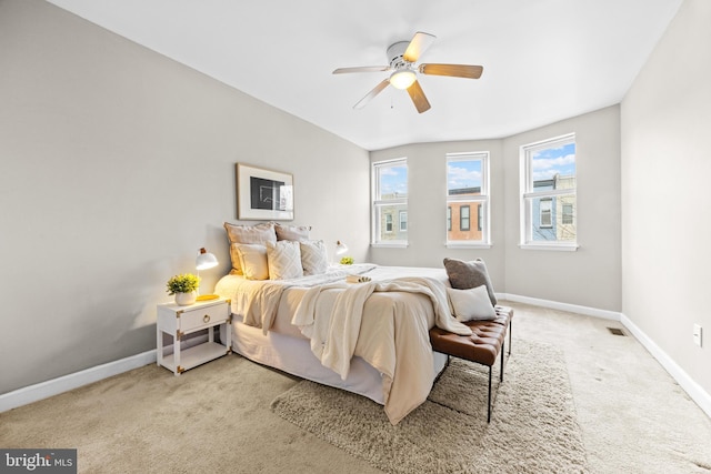 bedroom with carpet floors, visible vents, ceiling fan, and baseboards