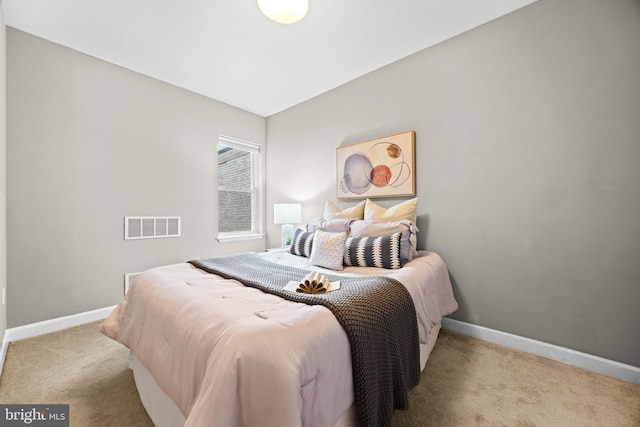 bedroom featuring light carpet, visible vents, and baseboards