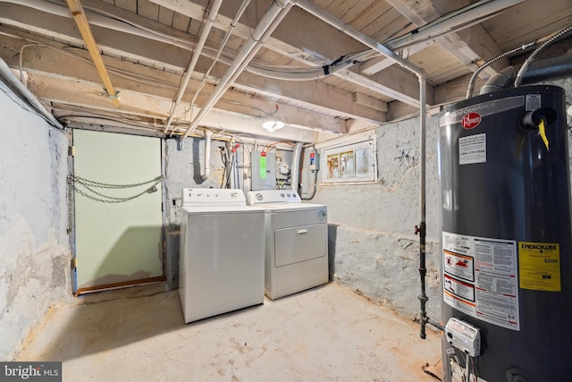 basement with electric panel, water heater, and washer and dryer