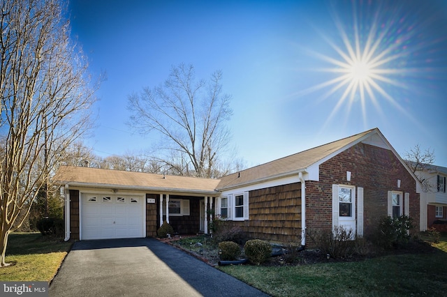 ranch-style home featuring a garage and driveway