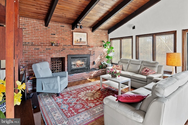 living room with vaulted ceiling with beams, wooden ceiling, a fireplace, and wood finished floors