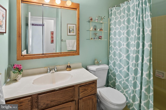 full bathroom featuring shower / tub combo, vanity, and toilet