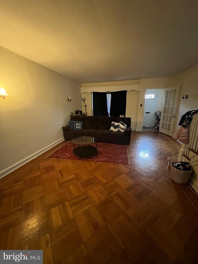 unfurnished living room with parquet flooring