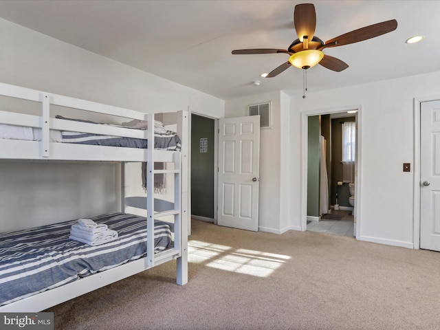 carpeted bedroom with ensuite bath, baseboards, visible vents, and recessed lighting