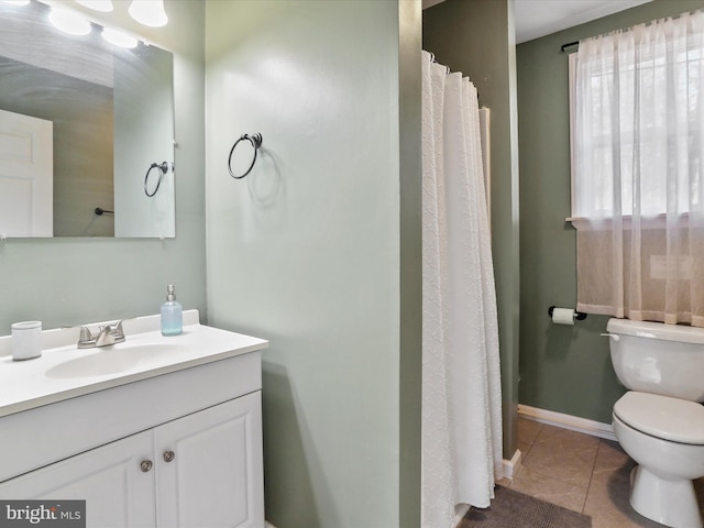 full bath with toilet, vanity, baseboards, and tile patterned floors