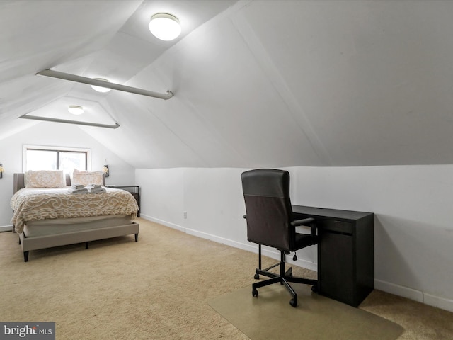 bedroom with carpet floors, lofted ceiling, and baseboards