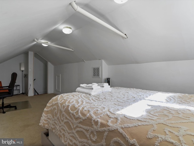 carpeted bedroom featuring lofted ceiling