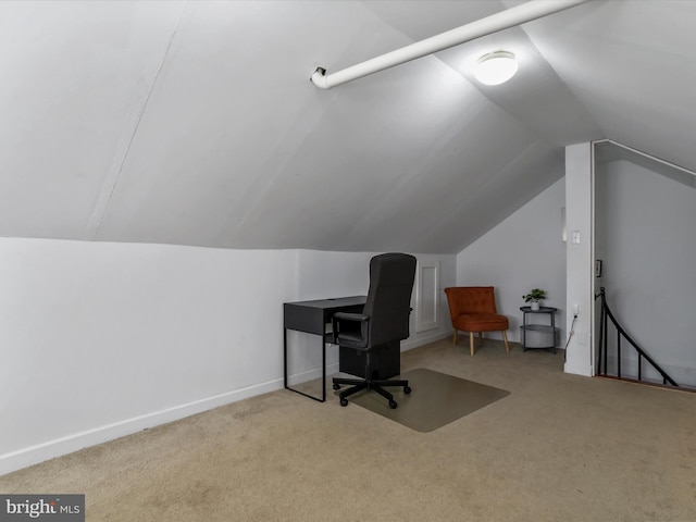 office space featuring carpet floors, vaulted ceiling, and baseboards