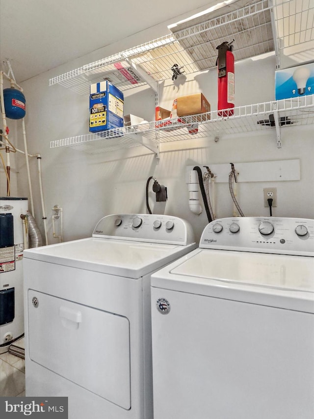 laundry area with water heater, laundry area, and independent washer and dryer