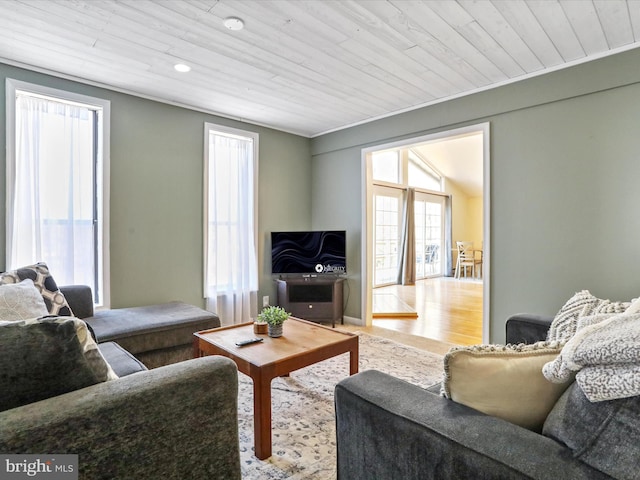 living room featuring wooden ceiling, crown molding, and wood finished floors