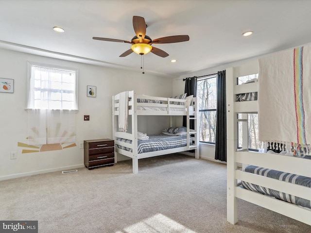 carpeted bedroom featuring baseboards, multiple windows, and recessed lighting