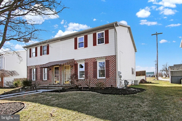 colonial inspired home with central air condition unit and a front lawn