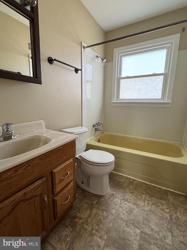 bathroom with washtub / shower combination, vanity, and toilet