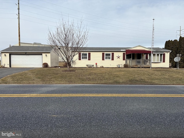 ranch-style home with a garage and a front lawn