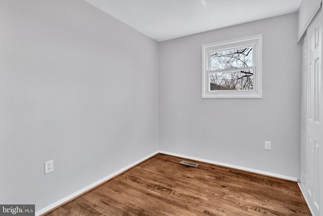 spare room with wood-type flooring