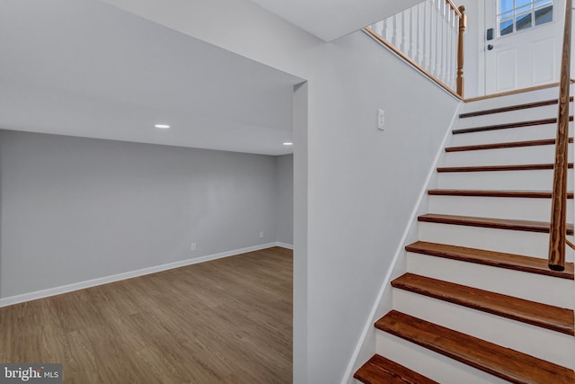 stairs with hardwood / wood-style floors