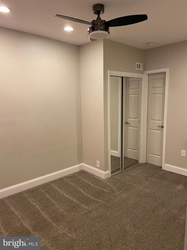 unfurnished bedroom featuring a closet, ceiling fan, and carpet