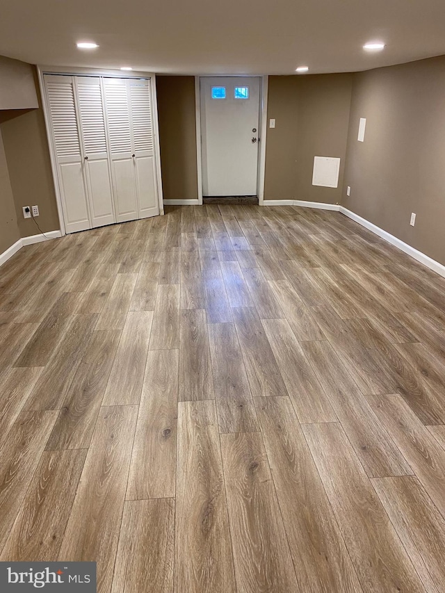 basement with hardwood / wood-style floors