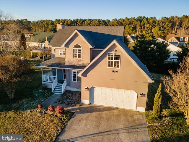 view of front property featuring a garage and covered porch