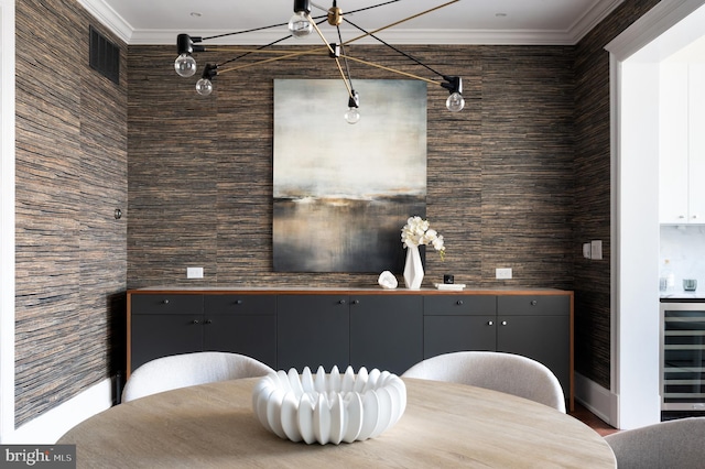 bar featuring visible vents, beverage cooler, and crown molding