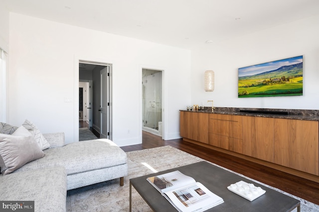 living room with dark wood finished floors and baseboards