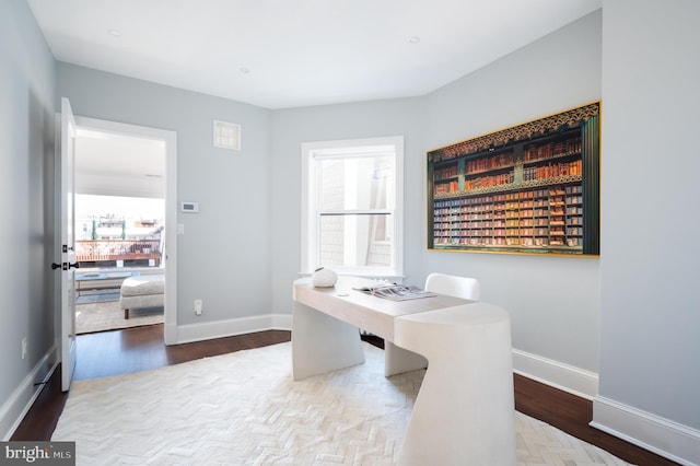 office area featuring baseboards and wood finished floors