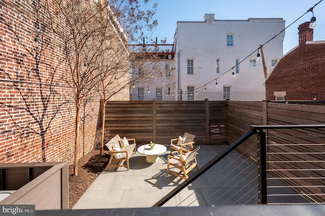 wooden terrace with a patio and fence