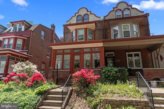 view of front of property with brick siding and a porch