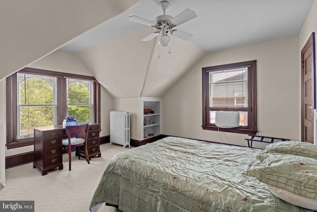 bedroom featuring vaulted ceiling, light carpet, baseboards, and radiator heating unit