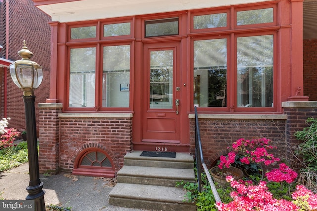 property entrance featuring brick siding