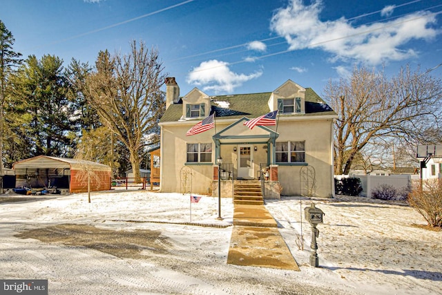 view of front of home with a chimney, fence, and stucco siding