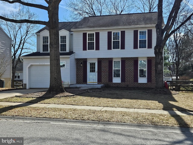 view of front of house with a garage, driveway, and brick siding