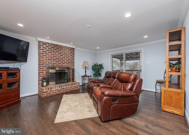 living room featuring ornamental molding, a brick fireplace, wood finished floors, and recessed lighting