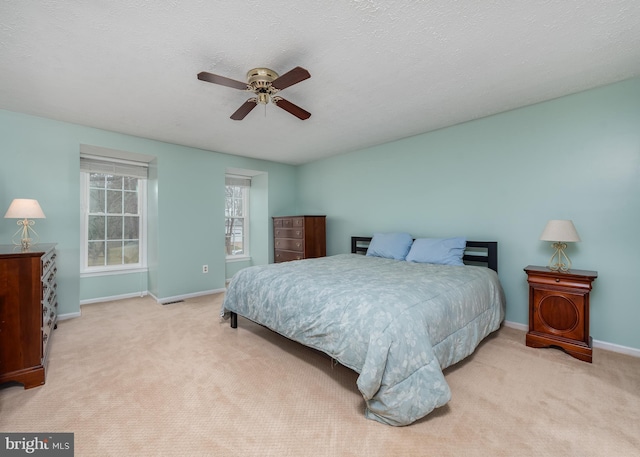 bedroom with a textured ceiling, carpet, and baseboards