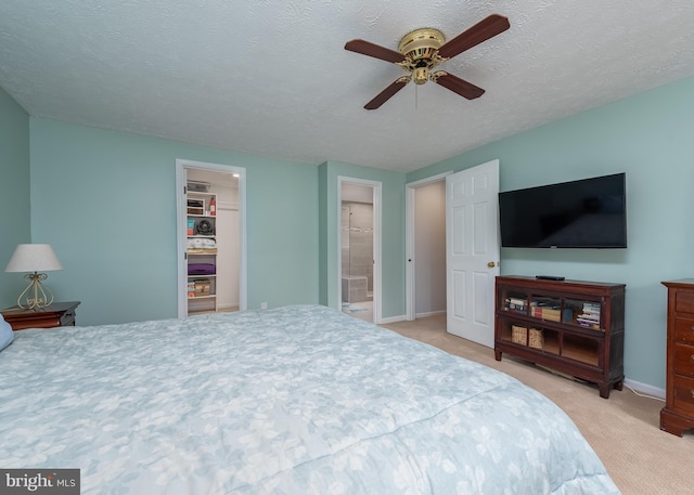 carpeted bedroom with a ceiling fan, a textured ceiling, and baseboards