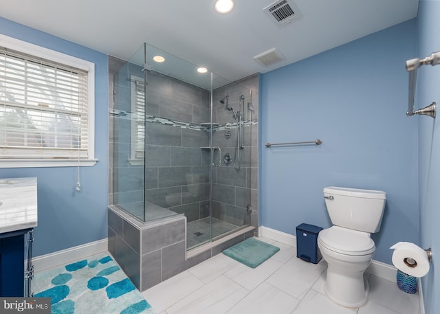 bathroom with a stall shower, baseboards, visible vents, toilet, and vanity