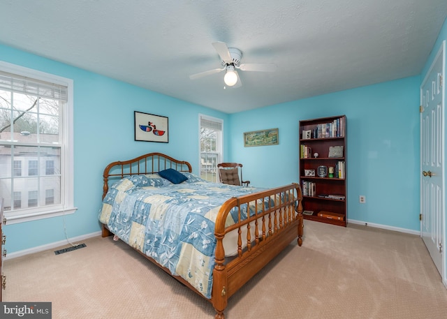 bedroom featuring carpet flooring, visible vents, and baseboards