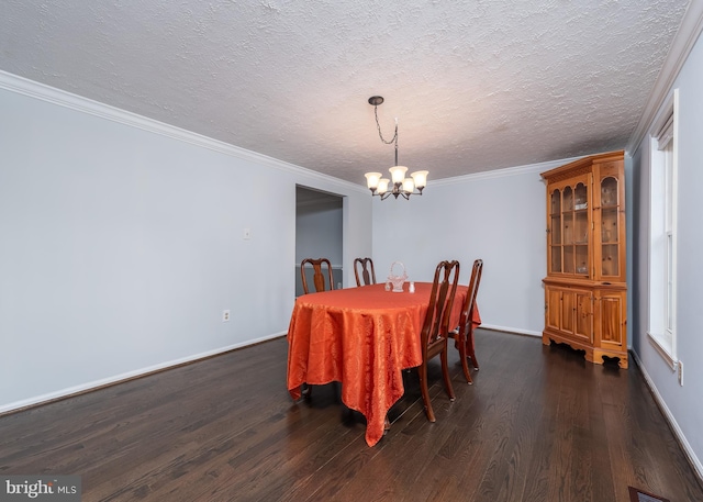 dining room featuring baseboards, ornamental molding, dark wood finished floors, and an inviting chandelier