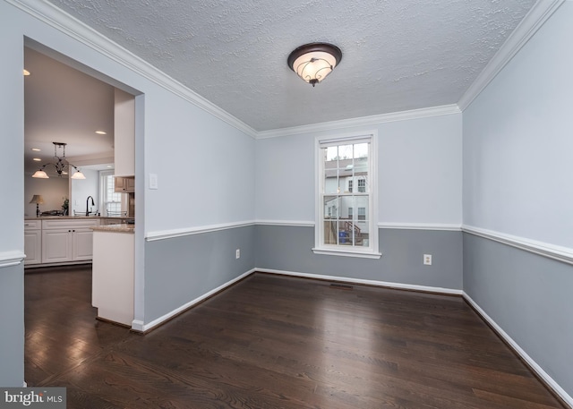 spare room featuring dark wood-style floors, plenty of natural light, and ornamental molding