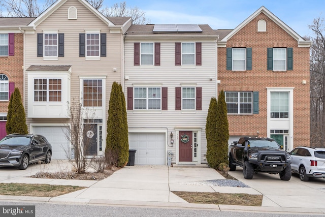 townhome / multi-family property featuring solar panels