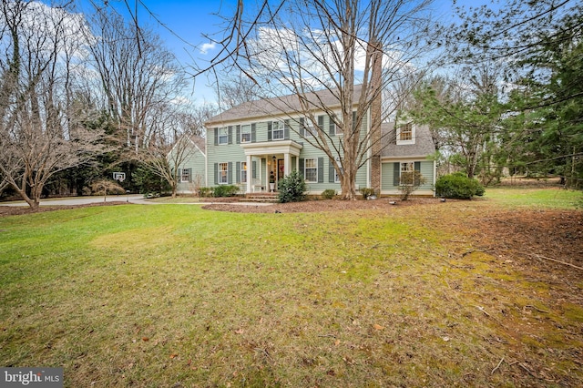 colonial-style house with a front yard