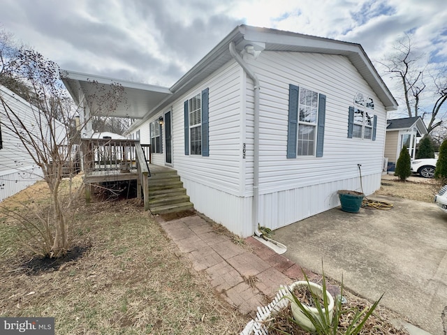 view of property exterior with a deck