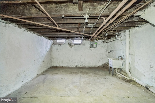 basement featuring sink and electric panel