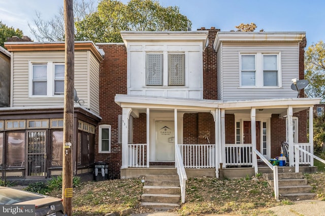 townhome / multi-family property with a porch