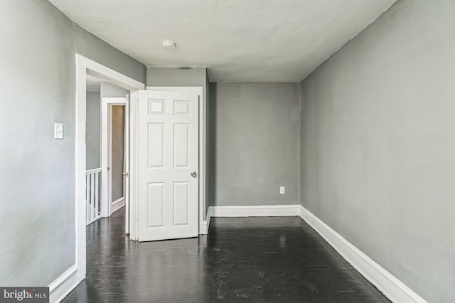 spare room featuring dark hardwood / wood-style floors