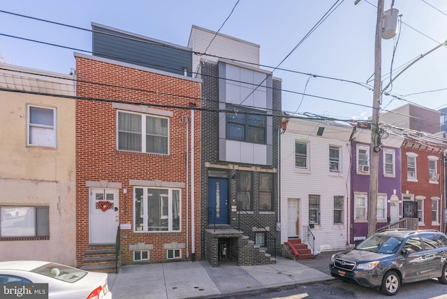 view of front facade featuring brick siding and entry steps