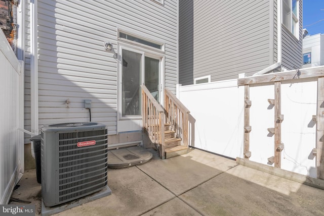 exterior space featuring fence, central air condition unit, and a patio area