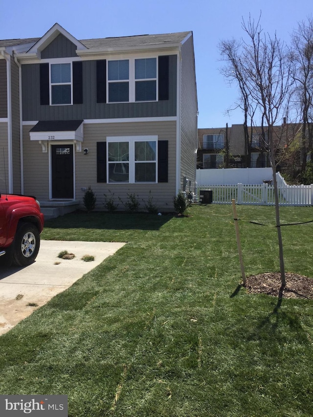 view of front of house featuring cooling unit and a front yard